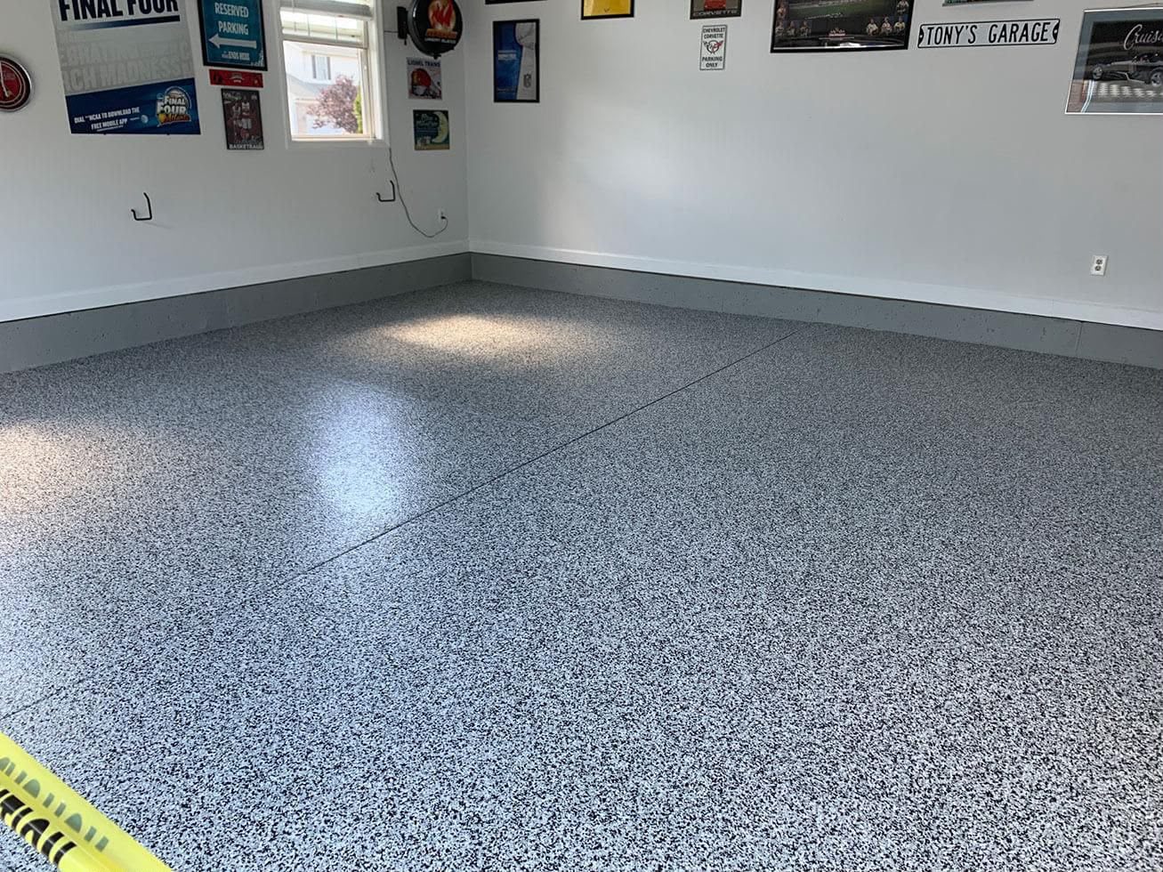 Installer applying a seamless epoxy coating with a squeegee